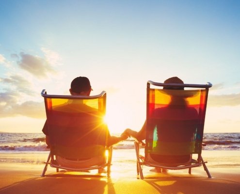 A couple relaxing on the beach, not having to worry about signing documents outside of canada