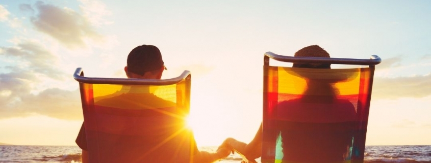 A couple relaxing on the beach, not having to worry about signing documents outside of canada