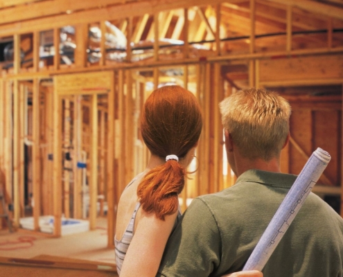 A happy couple overlooks the progress on their home construction.