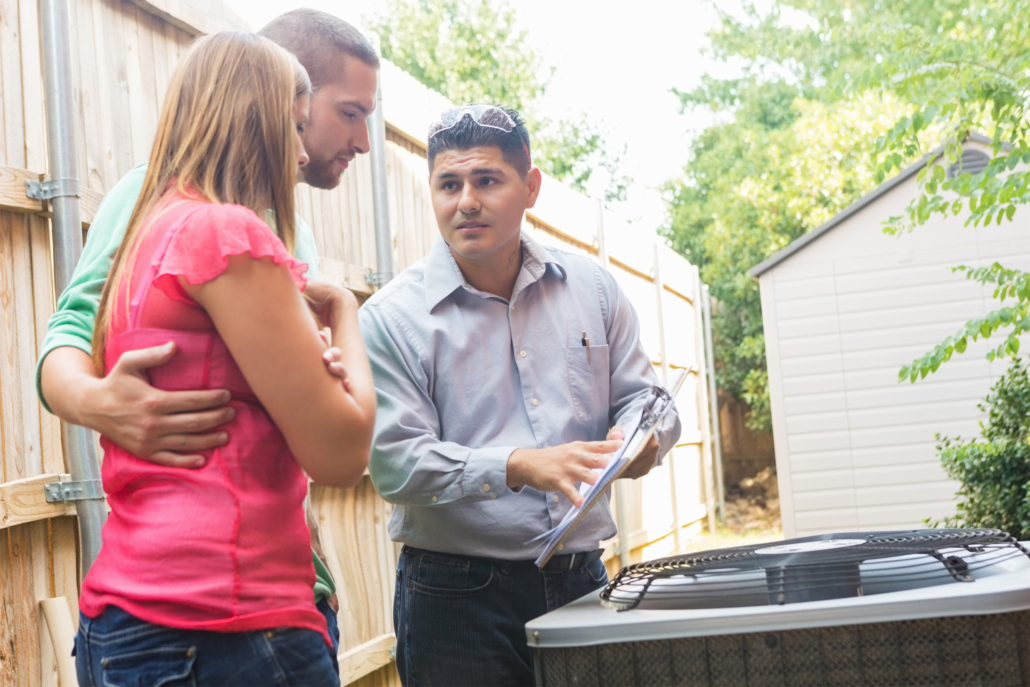 Appraiser with a couple reviewing paperwork