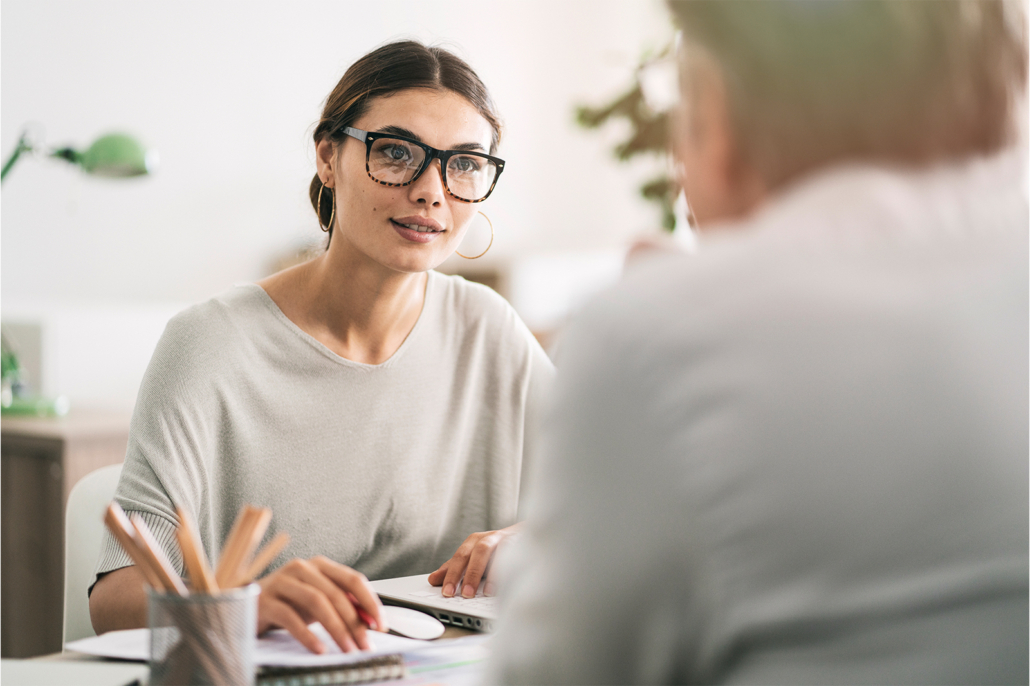 Woman at a desk with a client