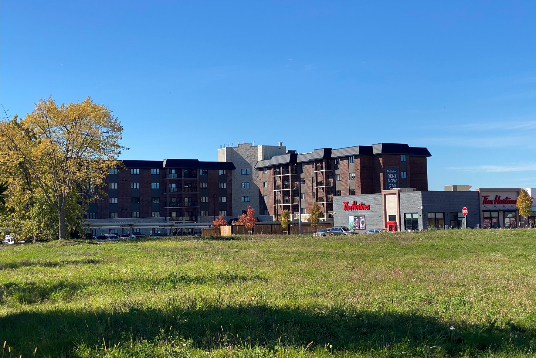 Tim Hortons building with apartments in the distance